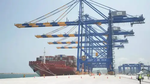 The Adani Group has announced plans to invest an additional Rs 20,000 crore to complete the remaining phases of the Vizhinjam International Seaport in Kerala. This port, the first transshipment port in India, is being developed by Adani Ports and Special Economic Zone Ltd (APSEZ) under a public-private partnership model at a total cost of approximately Rs 8,867 crore. Managing Director Karan Adani emphasized that the port will significantly reduce logistics costs for Indian manufacturers by 30 to 40 percent.