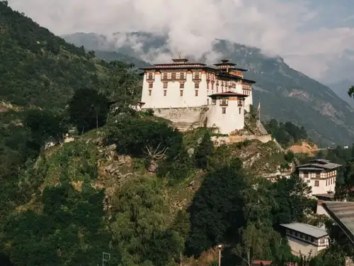 Bhutan's sustainable development fee has not deterred tourists, with no cap on visitor numbers. The country charges USD 100 per night for foreign visitors, except Indians who pay Rs 1,200. Bhutan promotes a 'High value, Low volume' tourism policy, focusing on environment conservation and sustainability. The revenue supports free healthcare, education, and infrastructure projects.